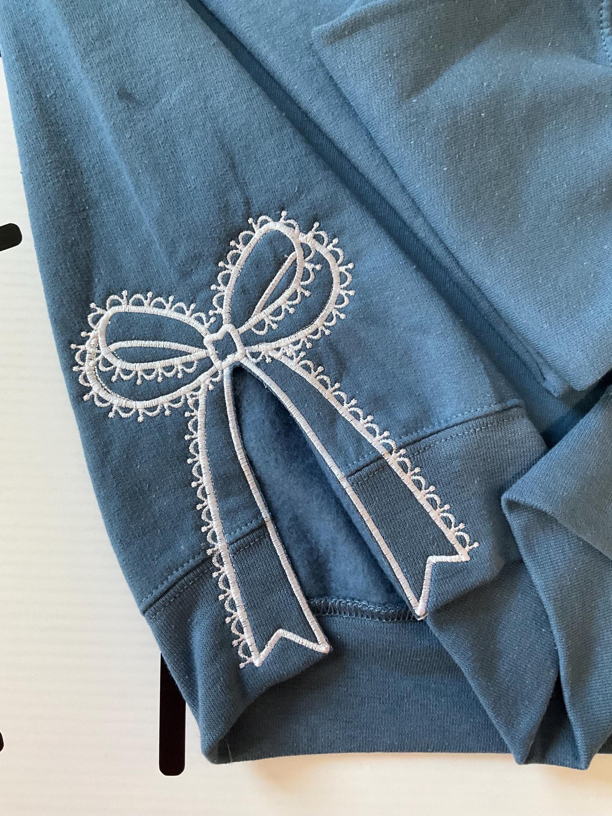 Embroidered Side Bow Sweatshirt: Classic Lace Design